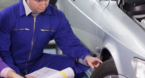 mechanic and women checking tyre