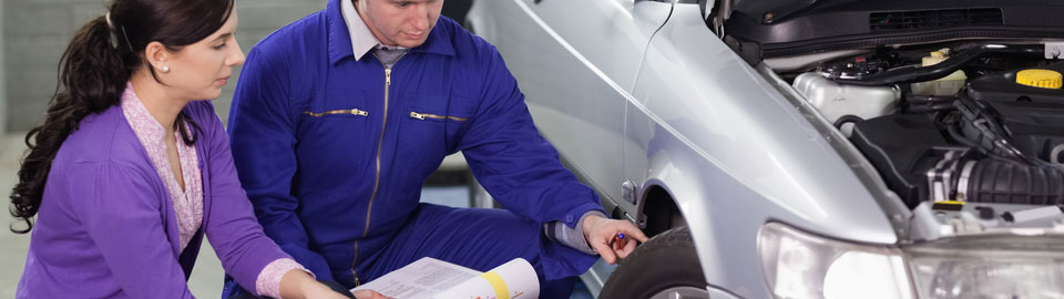 mechanic and women checking tyre
