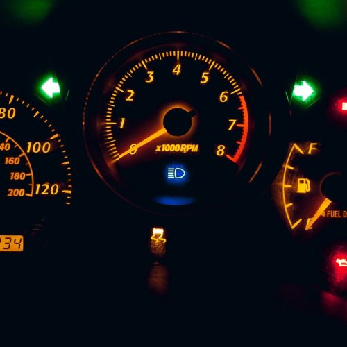 a close up of a car dashboard with warning lights